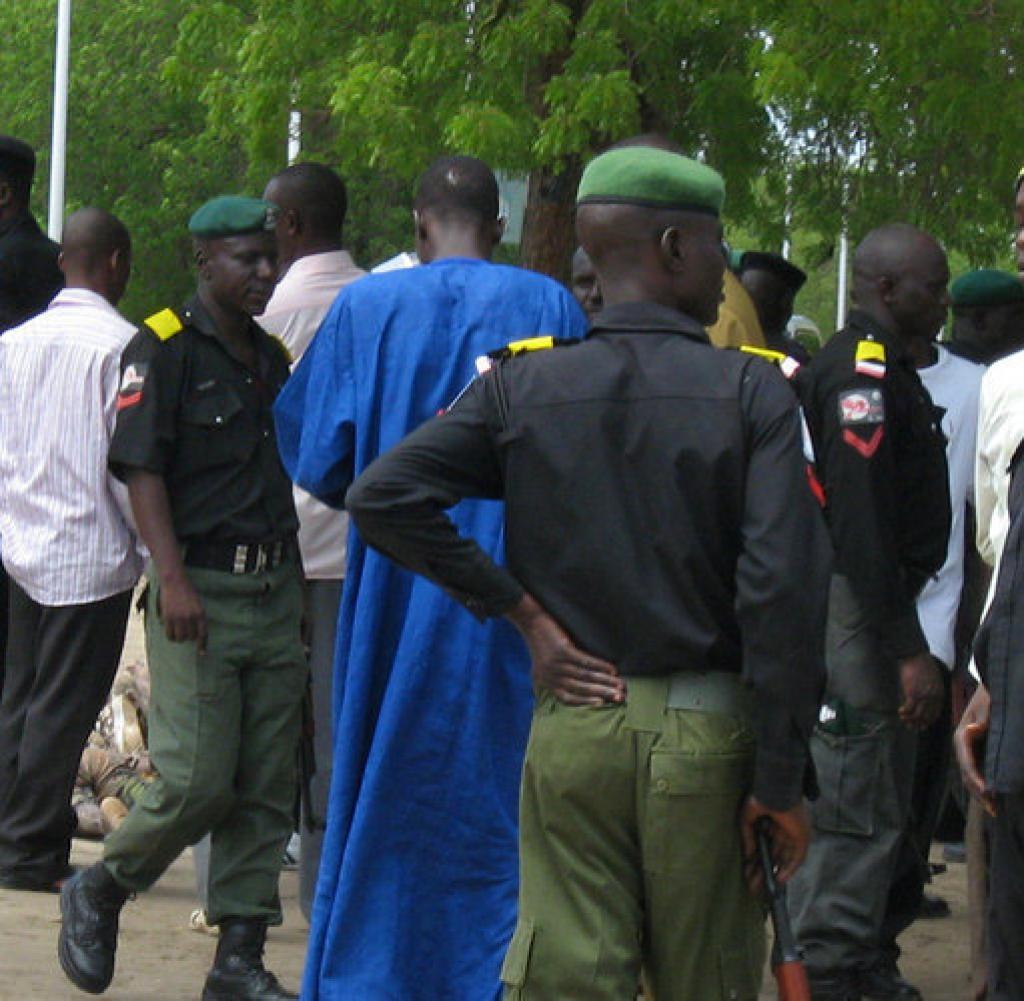 Police stand alongside bodies of dead Islamic militants, in the street in front of police headquarters in Maidugiri, Nigeria, Wednesday, July 29, 2009